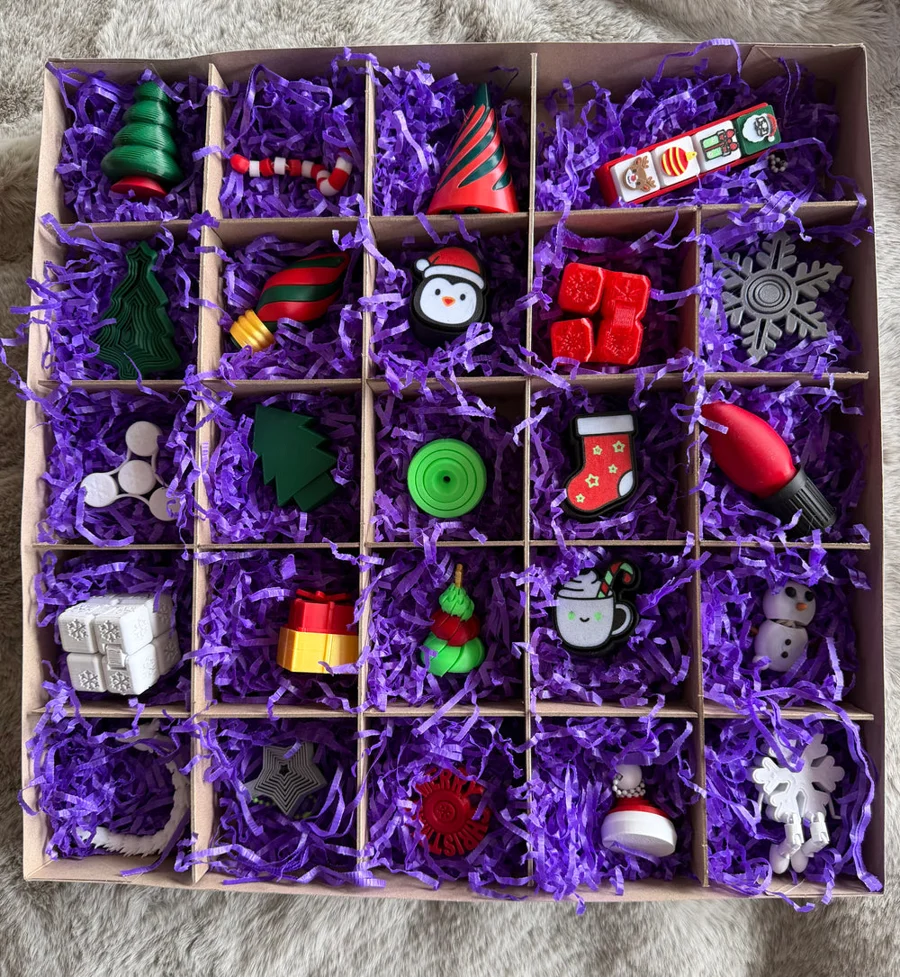 Christmas fidgets nestled in purple paper inside the TobesVerse advent calendar