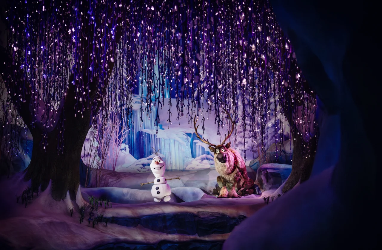 Olaf and Sven beneath glowing branches inside Frozen Ever After at Disneyland Paris