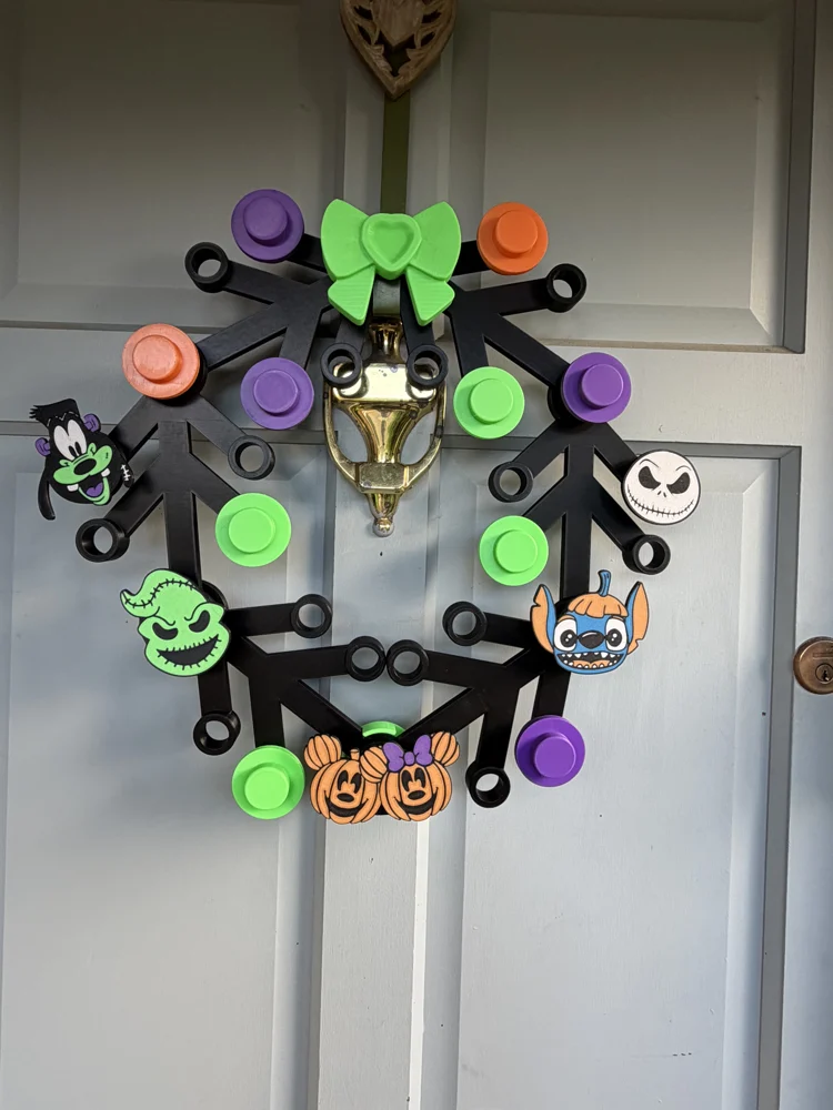 Disney Halloween wreath with colourful buttons, spooky character faces and a green bow
